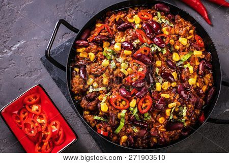Chili Con Carne In A Clay Bowl On A Concrete Or Stone Rustic Background- Traditional Dish Of Mexican