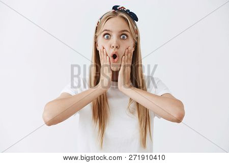 Waist-up Shot Of Speechless Shocked And Stunned Young Emotive Girl With Fair Hair In Headband Foldin