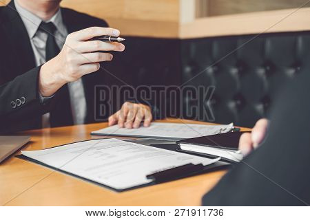 Senior Manager Reading A Resume During A Job Interview Employee Young Man Meeting Applicant And Recr