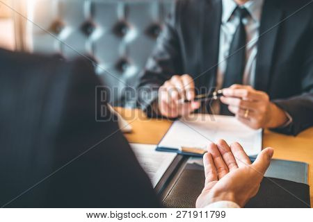 Senior Manager Reading A Resume During A Job Interview Employee Young Man Meeting Applicant And Recr