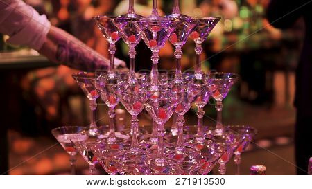 Glasses With Martini Cocktail With Ultraviolet Color Illumination. Clip. Champagne Slide. Pyramid Or