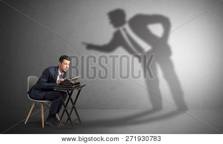 Little man working and a big shadow arguing with him