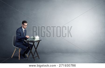 Man working hard on a typewriter in an empty space
