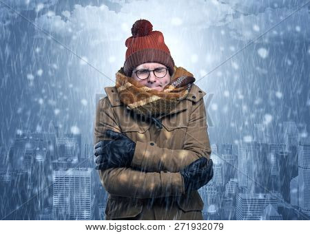 Young man freezing in warm clothing with city concept
