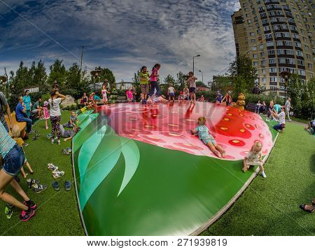Moscow, Russia - July 26, 2018: Unidentified Joyful Children Are Jumping Fun On Inflatable Trampolin