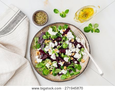 Beetroot Salad With Feta, Cheese, Walnuts, Corn Salad On White Table, Top View