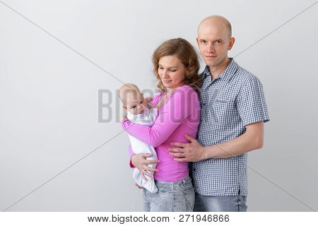 Family, Childhood And Parenthood Concept - Father, Mother Holding Cute Baby Over White Background Wi