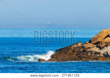 Sea Waves Breaking On A Rocks. Deep Blue Sea Waves Hit Cliff, Hit Rocks Cliff. Mighty Sea Waves Brea