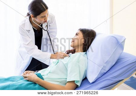 Asian Doctor make routine health check with patient in hospital ward