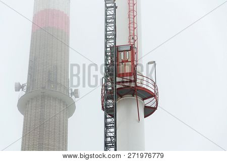 Old A New Chimneys At Heating Plant Covered In Fog, Cloudy Winter Day, Low Angle View, Energy Produc