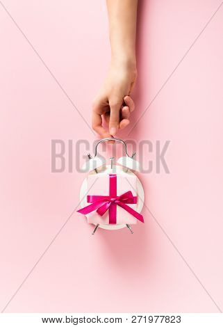 Valentines Day Concept Pastel Minimalis, Time To Gift, Alarm Clock And Hand On Pink Background