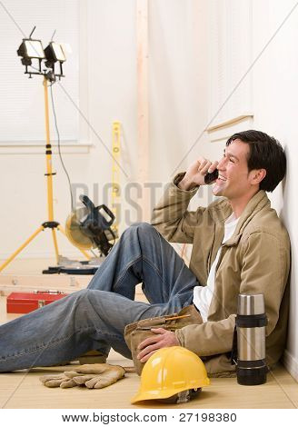 Construction worker talking on celluar phone