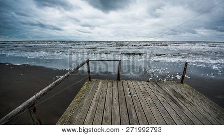 Rusty Bridge Stretching Into The Lifeless Sea, Caspian Sea Under Blue Sky In Early September, Snag O
