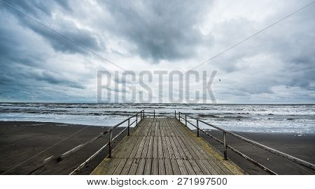 Rusty Bridge Stretching Into The Lifeless Sea, Caspian Sea Under Blue Sky In Early September, Snag O