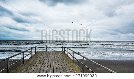 Rusty Bridge Stretching Into The Lifeless Sea, Caspian Sea Under Blue Sky In Early September, Snag O
