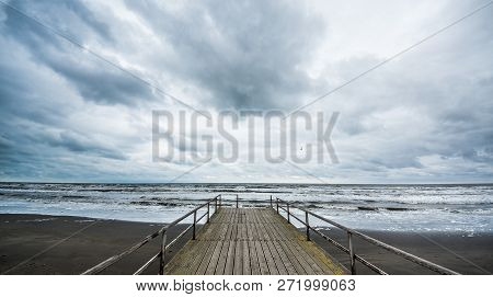 Rusty Bridge Stretching Into The Lifeless Sea, Caspian Sea Under Blue Sky In Early September, Snag O