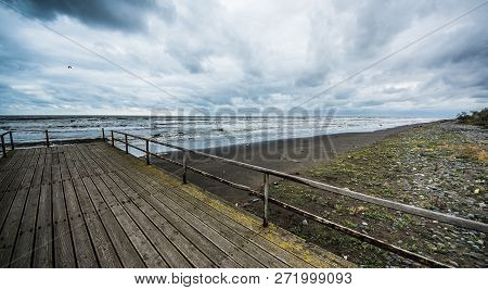 Rusty Bridge Stretching Into The Lifeless Sea, Caspian Sea Under Blue Sky In Early September, Snag O