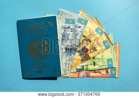 Dubai / Uae - June 10, 2020: Kazakhstan Passport With National Currency - Tenge On Blue Background. 