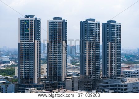 View From The High Floor Of The Streets Of Bangkok. Tall Buildings And Roofs Of Small Houses. City L