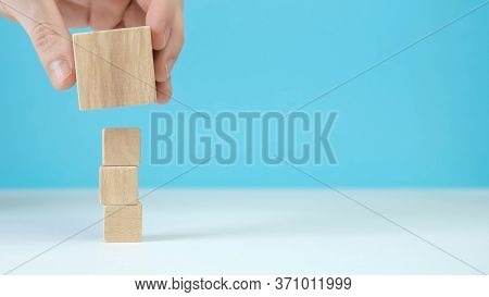 Hand Arranging Wood Block Stacking As Step Stair On Wooden Table. Business Concept For Growth Succes