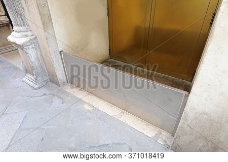 Stainless Steel Bulkhead To Protect The Entrance To The Building During The High Tide In An Alley Of
