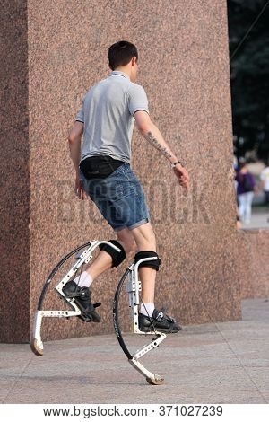 St. Petersburg, Russia - June 27,2013: Young Man Running On A Jumping Stilts. Area In St. Petersburg