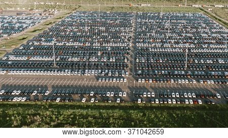 Huge Parking With New Cars In The Territory Of An Automobile Factory, Aerial View. Overproduction Of