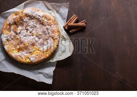 Homemade Apple Pie With Cinnamon On Brown Wooden Table
