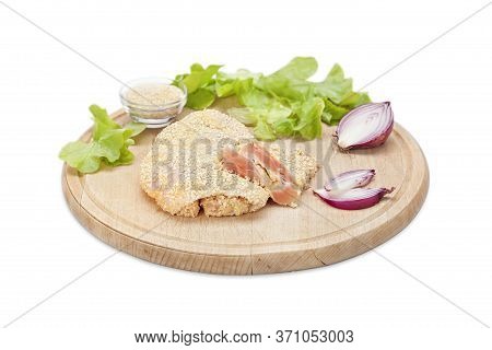 Raw Crispy Chicken Boneless Drumstick Breaded In Sesame And Bread Crumbs On A Wooden Board With Onio