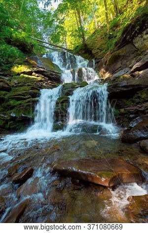 Great Water Fall In The Forest. Beautiful Nature Landscape. River Among The Rocks. Fresh Summer Scen