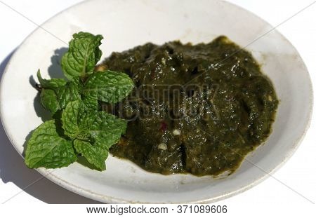 Closup Of Mint Leaves Paste Or Pudina Chutney In A Plate Isolated On White Background