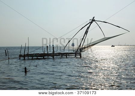 Calze a rete Kochi in chineese sul tramonto. Fort Kochin, Kerala, India
