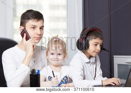 Teenager Talks On The Phone And Writes Down A Task And Children Interfere With Learning