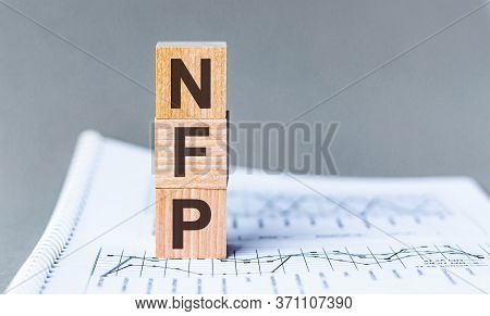 Word Nfp - Non Farm Payrolls - Acronym Concept On Cubes And Diagrams On A Gray Background. Business 