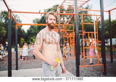 Sporty Muscular Man Drinking Water In Gym. Thirsty And Dehydration From Workout And Losing Too Much 