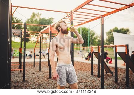 Sporty Muscular Man Drinking Water In Gym. Thirsty And Dehydration From Workout And Losing Too Much 
