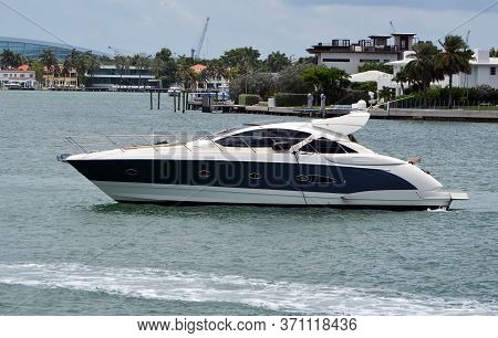 Back And White Motor Yacht Idling On The Florida Intra-coastal Waterway Off Of Miami Beach.