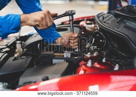Auto Check Up And Car Service Shop Concept. Mechanic Writing Job Checklist To Clipboard To Estimate 