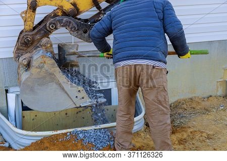 Bucket Moving Gravel In The Window Well On Basement Construction From Window Building Materials.