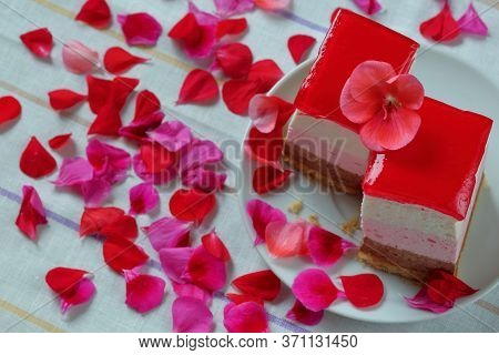 Two Pieces Of Tri Color Marshmallow Cake On White Plate, Dessert, With Red, Pink And Purple Petals A