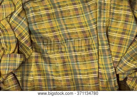 Chaotic Folded Green Checkered Fabric Background. A Detailed Shot Of The Texture Of Natural Fabric I