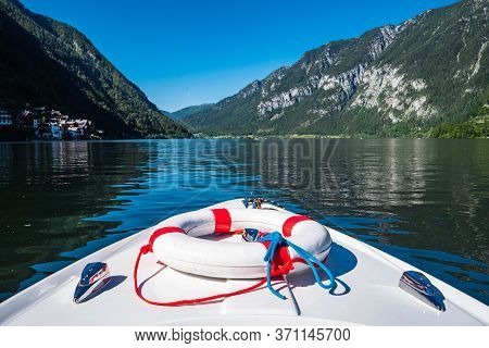 Boating On Lake Hallstatt With An Electric Motor Boat In A Beautiful Alpine Landscape, The Prow Or B
