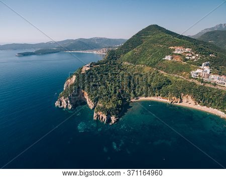 Mogren Beach, Near The Old Town Of Budva, In Montenegro. The Ancient Mogren Fort On The Mountain. Ro