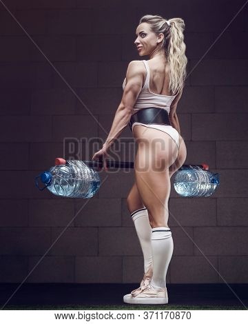 Fitness Woman Pumping Up Muscles Workout In Gym