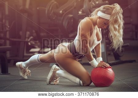 Fitness Woman Pumping Up Muscles Workout In Gym