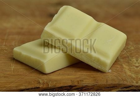 Nutrition, Diet And Junk Food. White Chocolate Bar Pieces Closeup.