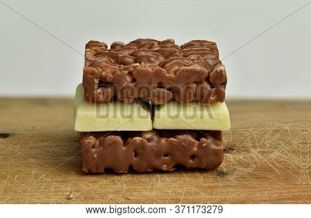 Nutrition, Diet And Junk Food. Chocolate Crispies Sweets And White Chocolate Forming A Chocolate San