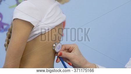 Doctor And Patient On Preventive Examination. Pediatrician Woman Listening To Heartbeat Heart, Lung 