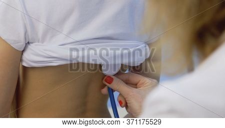 Doctor And Patient On Preventive Examination. Pediatrician Woman Listening To Heartbeat Heart, Lung 
