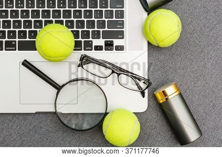 Top View Of Laptop, Sports Equipment, Tennis Ball, Shuttlecock, Glasses Aon The Sports Administratio